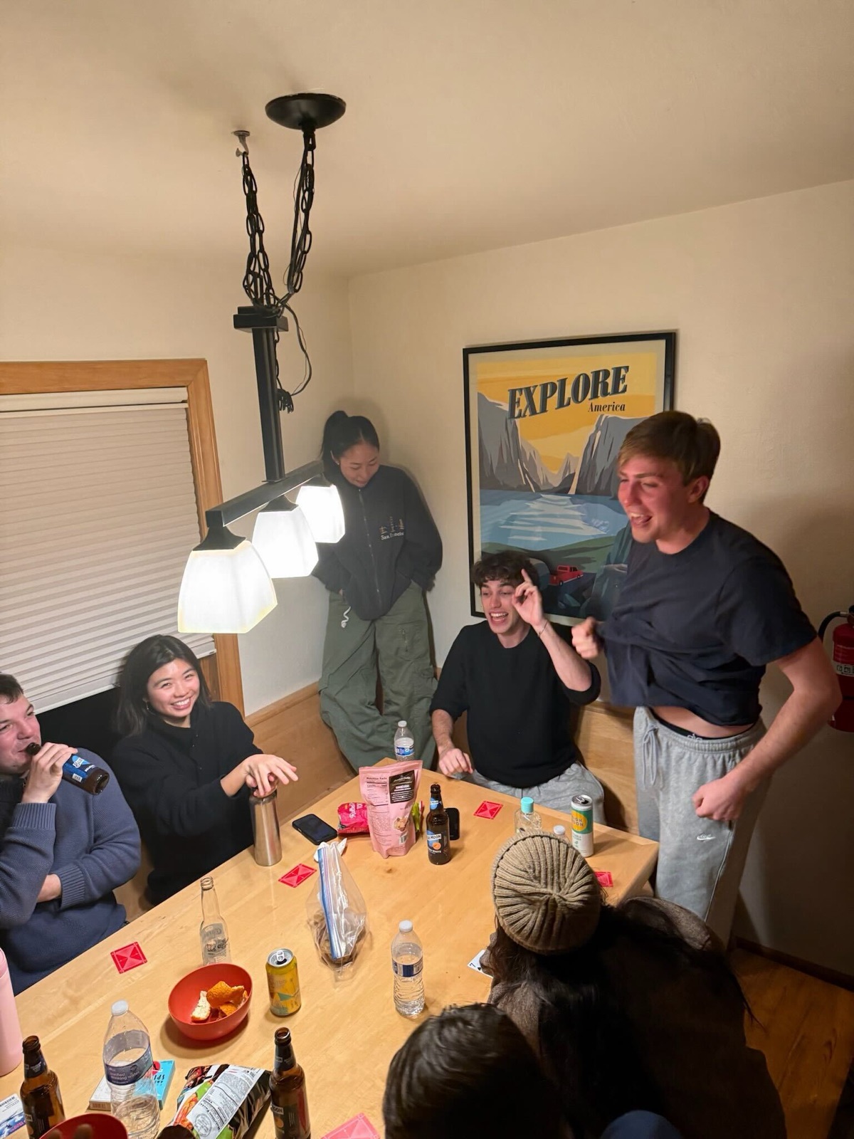Replo teammates laughing over cards and drinks at a Tahoe cabin