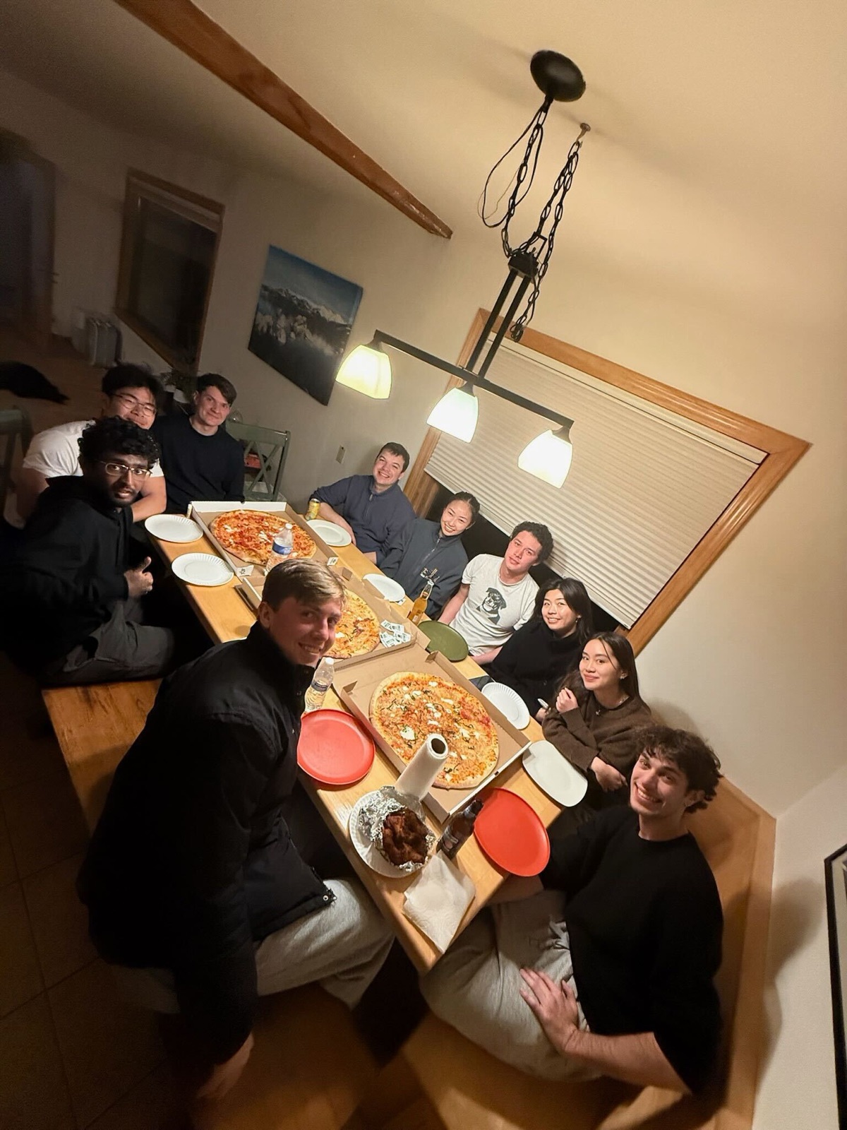 The Replo team sharing pizza at a cabin in Tahoe