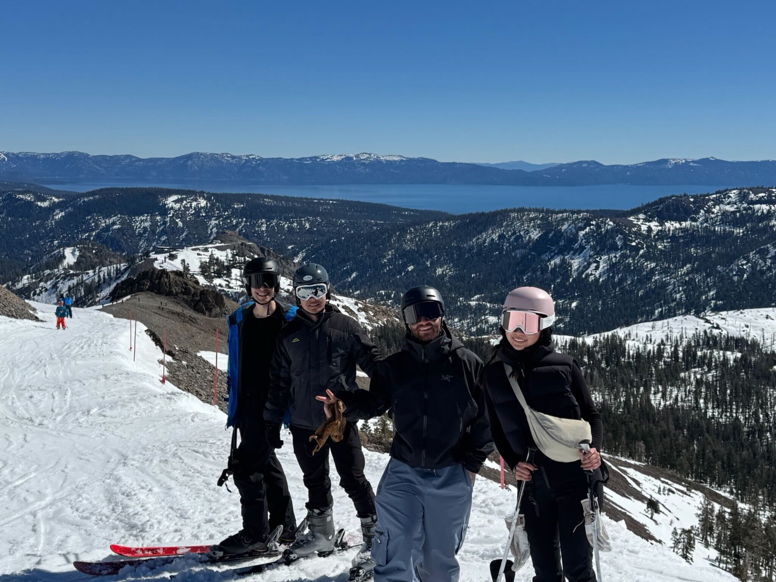 Four Replo teammates at a mountain summit above Lake Tahoe